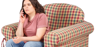 Young person sitting on couch phoning Court Network.