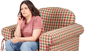 Young person sitting on couch phoning Court Network.